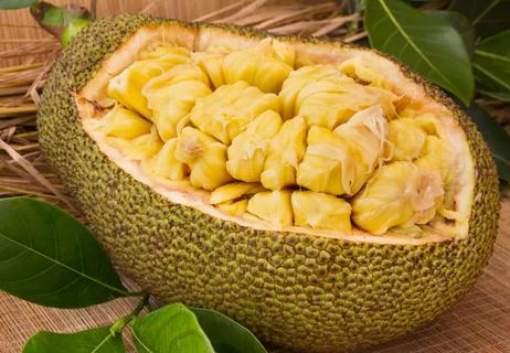 Jackfruit cut up in a bowl made out of the jackfruit itself, ready for eating.