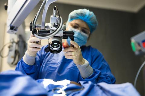 Healthcare provider positioning microscope in operating room for refractive surgery procedure