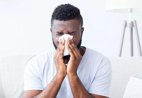 Man blowing nose mucus