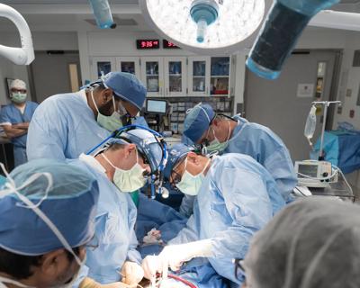 Surgeons in operating room performing heart transplant