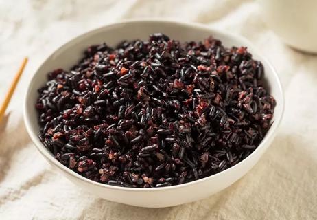 A bowl of cooked black rice, also known as "forbidden rice."