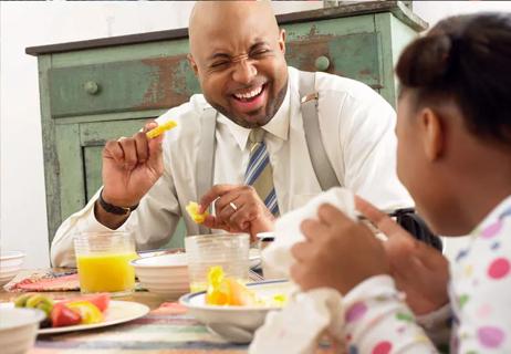 Father and daughter enjoying a healthy breakfast together