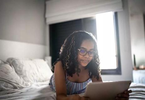 Child playing a video game on iPad.