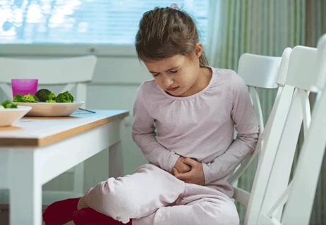 Young girl with stomach pains after eating