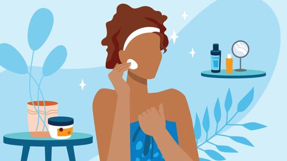 Person in towel in their bathroom applying lotion to their face