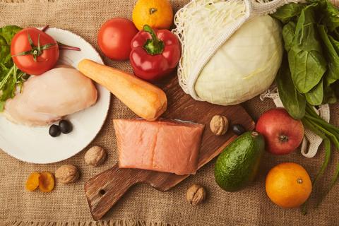 SIBO diet foods, including oranges, salmon, avocado, chicken and tomatoes