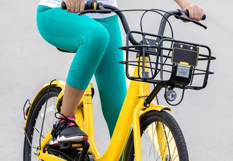 Closeup of woman riding bike focused on her knee
