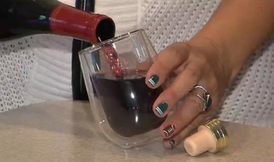 Woman pouring glass of wine.