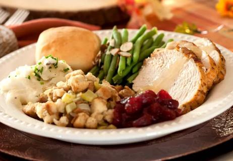 Thanksgiving dinner leftovers on a plate ready to eat.