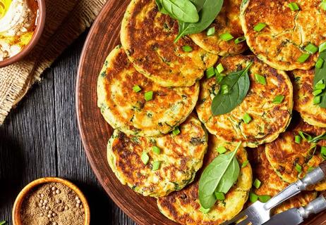 Chickpea spinach pancakes displayed on a plate with the angle from above