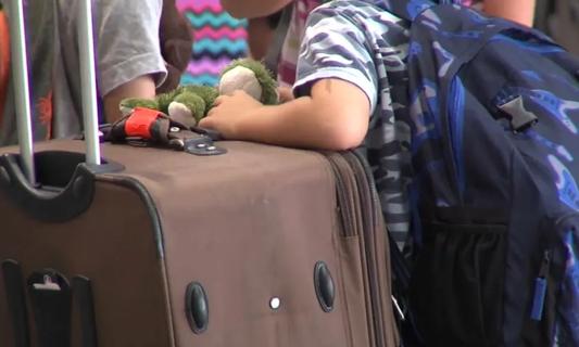 Child carrying luggage