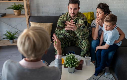 A soldier, their spouse and their child talking with a therapist