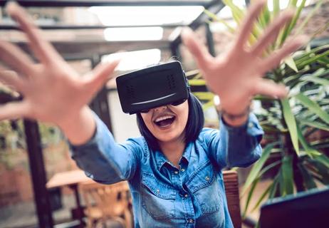 Woman gaming wearing virtual reality headset