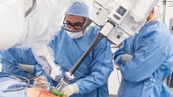 Surgeons in the operating room with the single-port robot