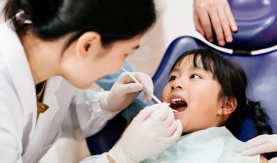Dentist examining a child's teeth