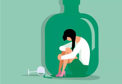 Forlorn person hugs knees to chest while sitting inside a giant green bottle