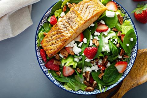 Filet of grilled salmon on strawberry, cheese, walnut salad