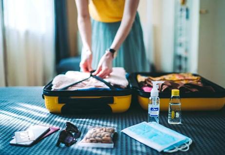 woman packing suitcase for vacation