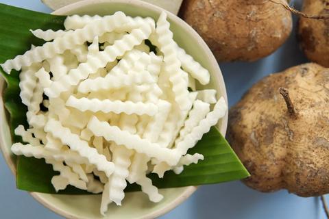 Jicama fries in a bowl, with whole jicama on table