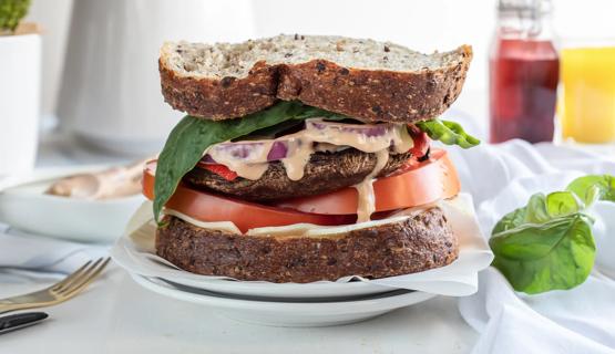 Portobello sandwich with lettuce, tomato, onion and dijon vinaigrette on multigrain bread