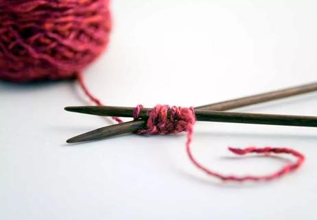 Ball and strand of crocheting yarn.