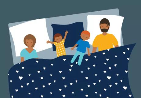 Parents and children sleep in large bed at night.