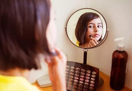 teenage girl applying makeup