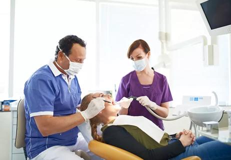 A person sitting in a dentist office getting a dental cleaning