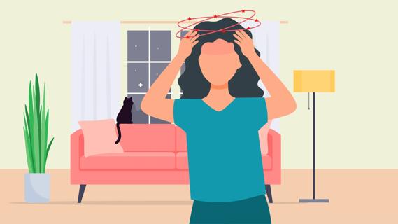 Person at home, with hands up to their head, feeling dizzy