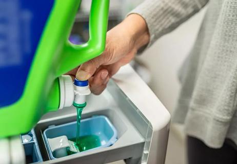 woman filling the washing machine with soap