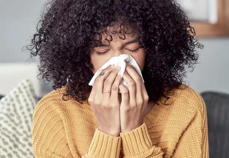 woman whiping nose with tissue