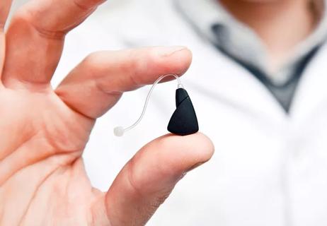 doctor holding a hearing aid