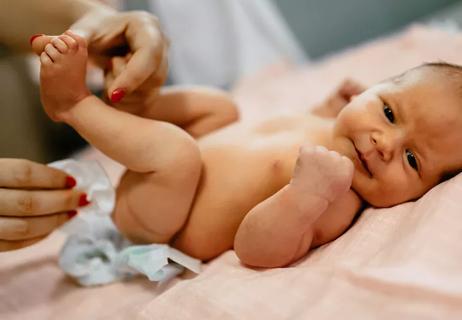 Baby having diaper changed