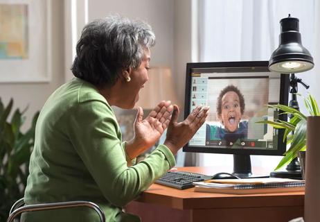 Excited grandma video shats with grandson from her living room.