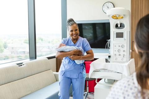 Nurse holding newborn baby