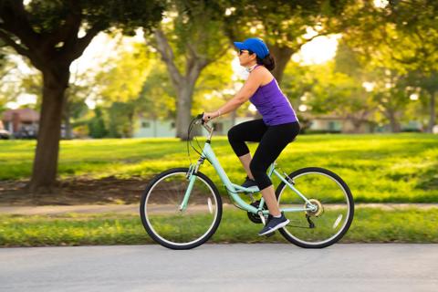 Person riding bike on pavement outside
