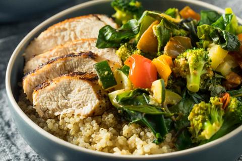 Bowl of quinoa, chicken, vegetables and spinach