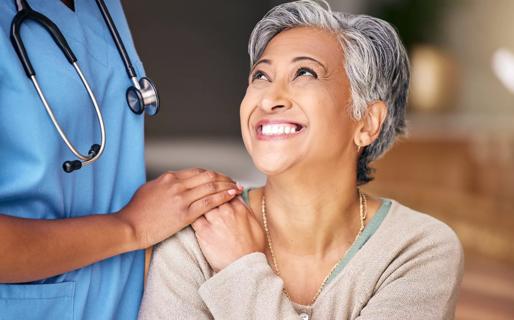 Nurse laughing with elderly patient