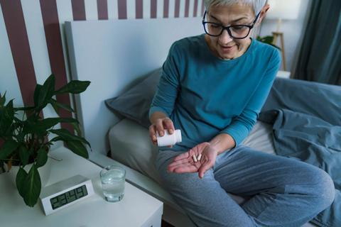 Woman taking medication before going to bed