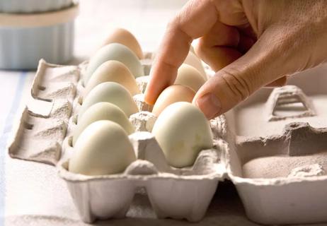 Selecting eggs from egg carton for heart healthy breakfast