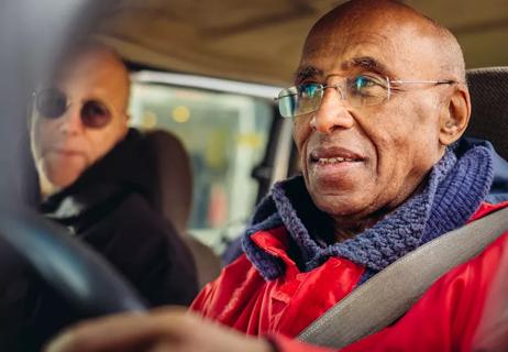 Elder person driving car with trepidation in his gaze.