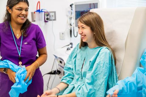 Teen patient sitting in exam room with gastroenterologist