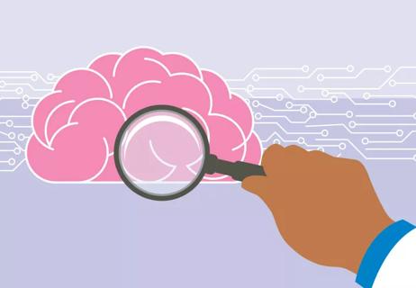 Hand holding magnifying glass examining the brain and data from a study.