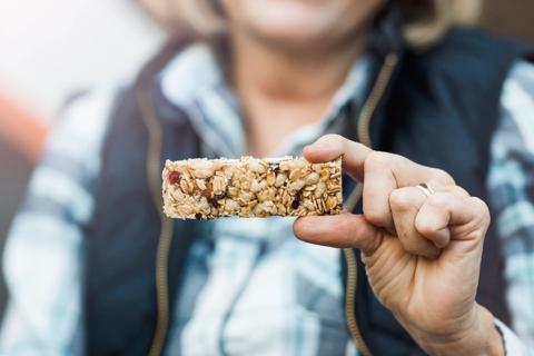 Person holding up a granola bar