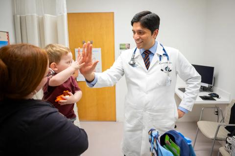 Dr. Amdani gives patient high five