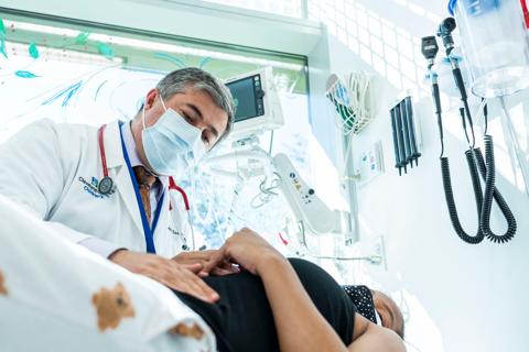 Clinician looking down at patient on exam table