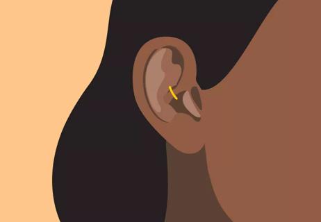 Person with a piercing in the cartilage of their ear.