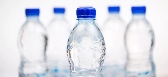 Bottles of water with blue caps