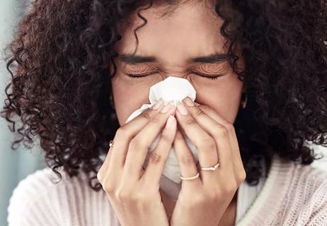 woman blowing her nose