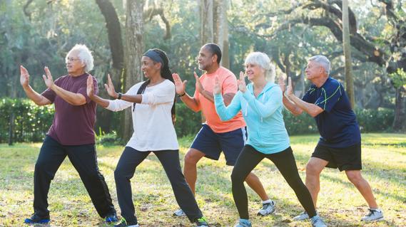 Group of older people doing tai chi outside